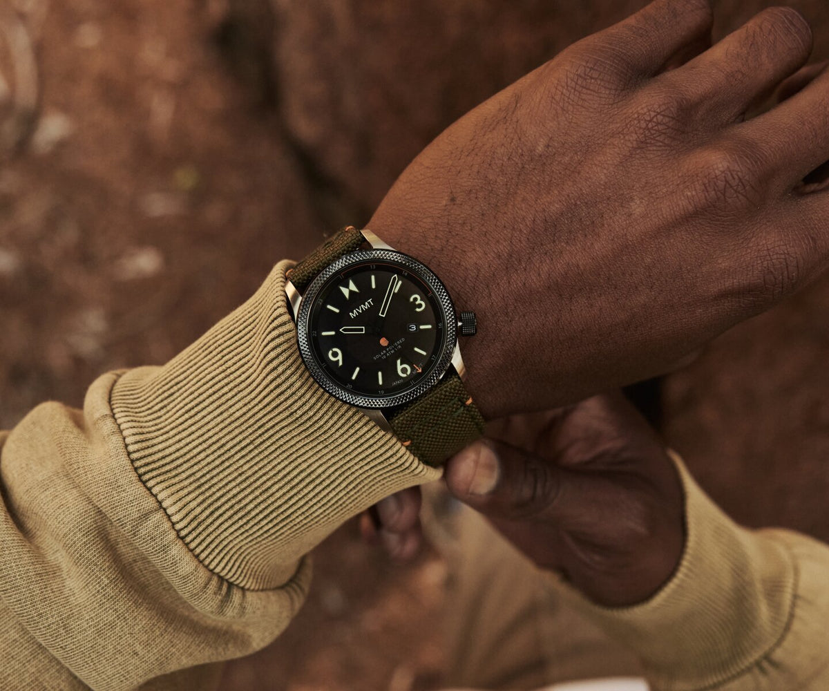 Man in a beige sweater wearing the Field II solar men's watch
